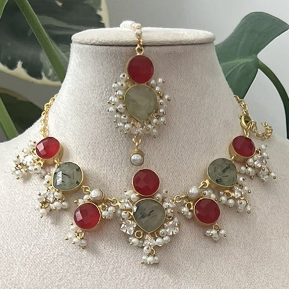 Jewelry set on a mannequin bust with green leaves in the background