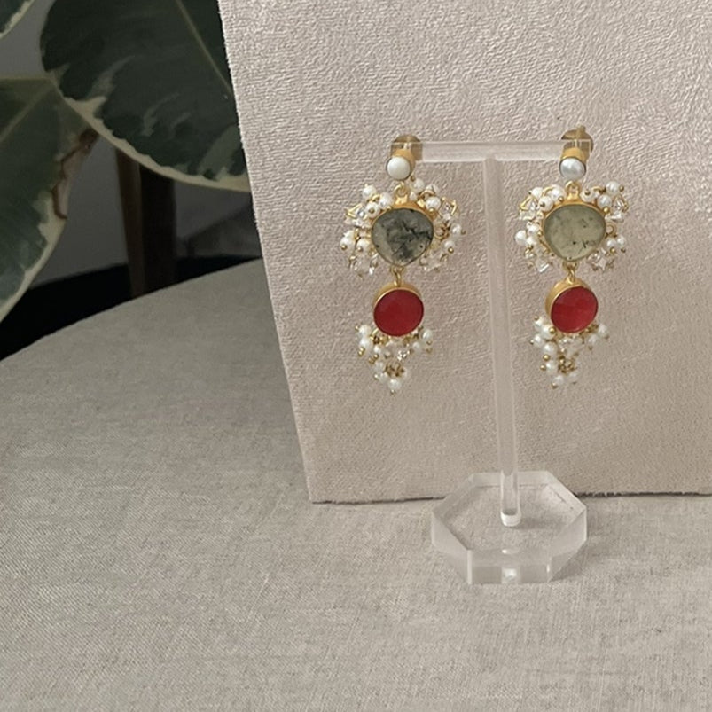 Jewelry set on a mannequin bust with green leaves in the background