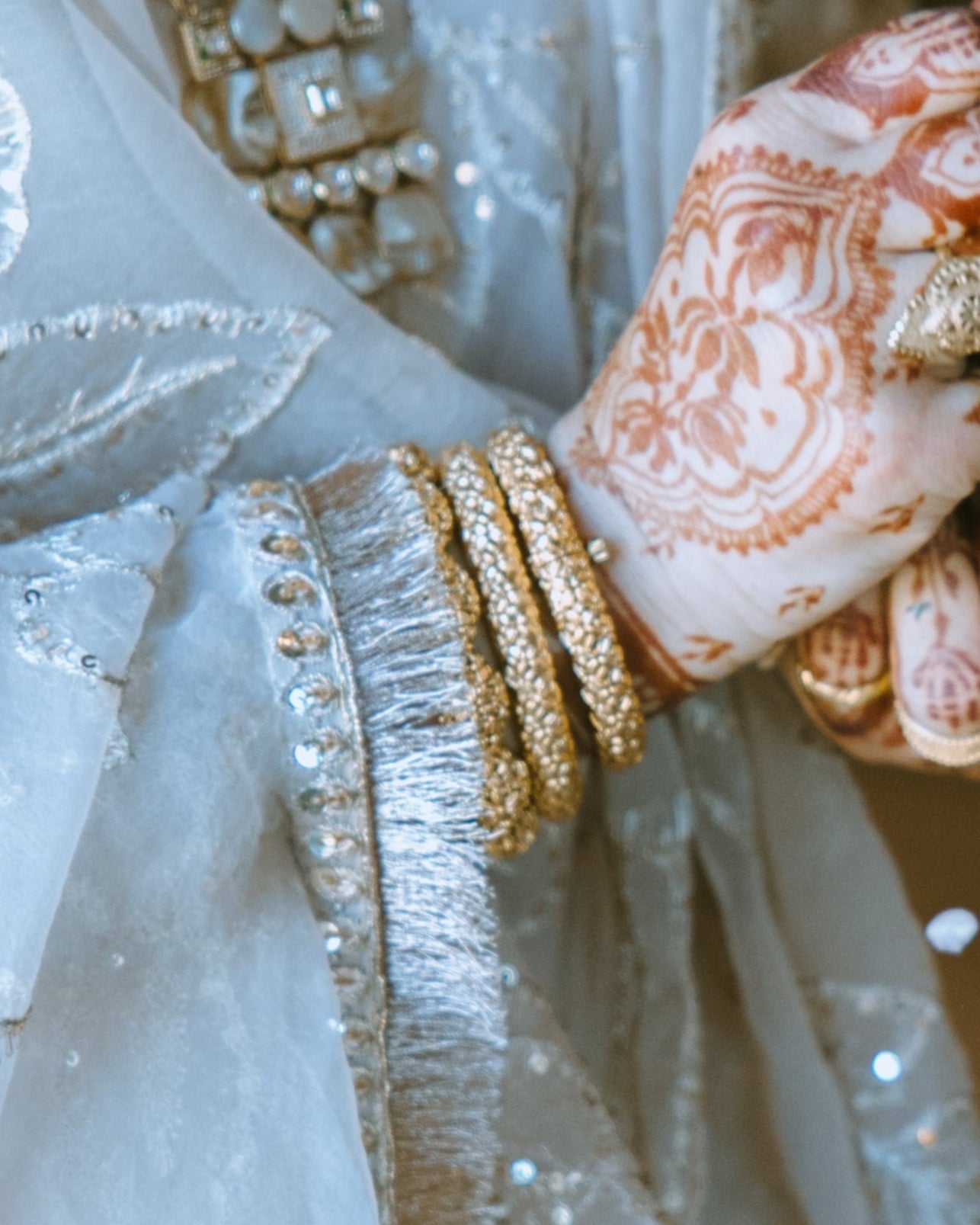 Antique gold kangan bangles worn by a woman at an indian wedding