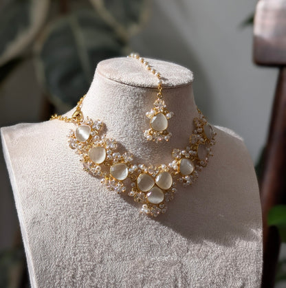 Gold necklace on a mannequin bust with a blurred background