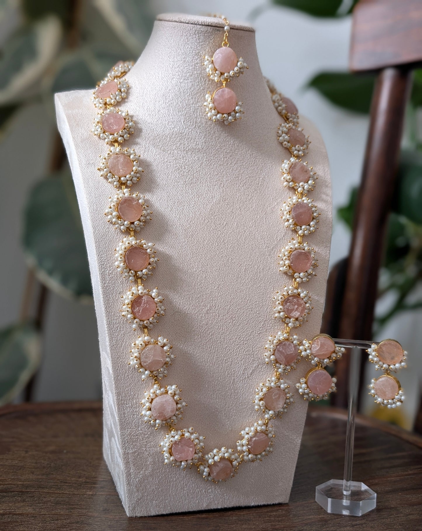 Jewelry set with necklace and earrings on a mannequin bust.