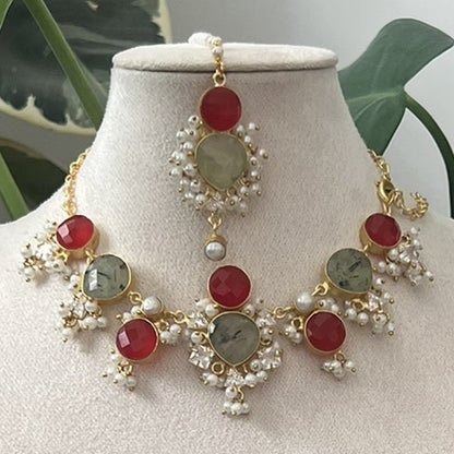 Jewelry set on a mannequin bust with green leaves in the background