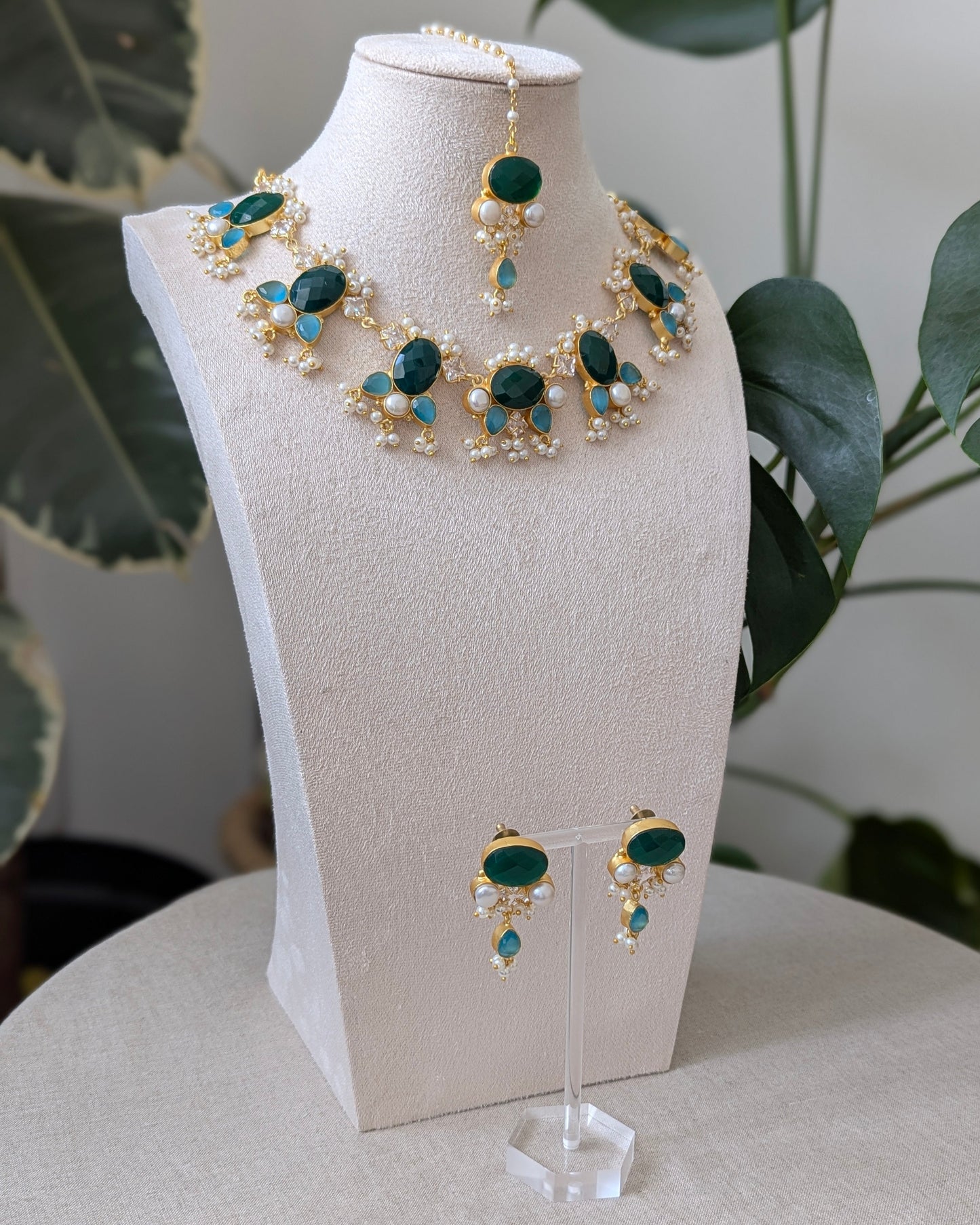 Jewelry set with necklace and earrings on a mannequin bust.