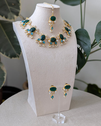 Jewelry set with necklace and earrings on a mannequin bust.