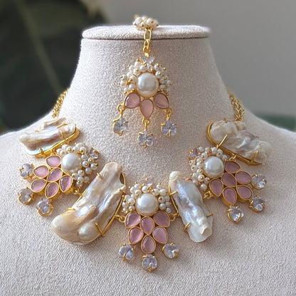 Jewelry set with necklace and earrings on a mannequin bust against a neutral background